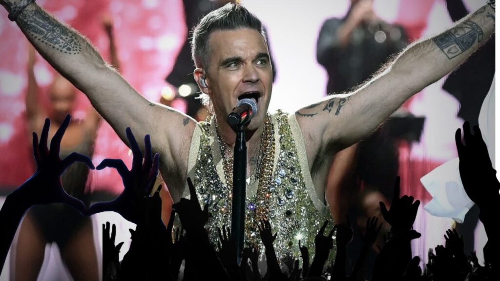 Robbie Williams en concierto con vestuario dorado y manos arriba del público